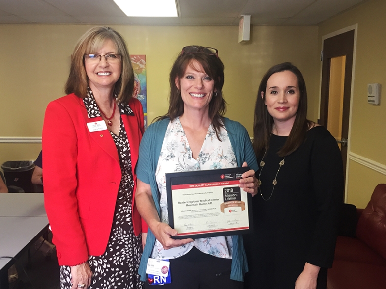 Three Women, One in Middle Holding Award