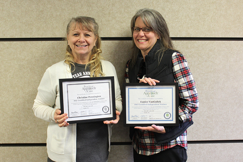 women holding their PAC certificates 