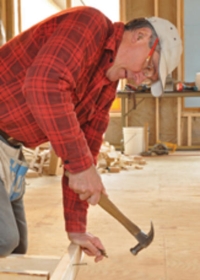 man hammering a nail